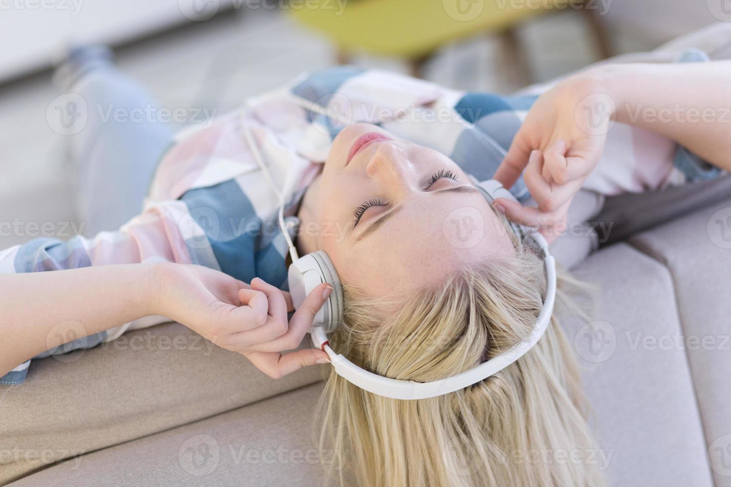 girl enjoying music through headphones photo