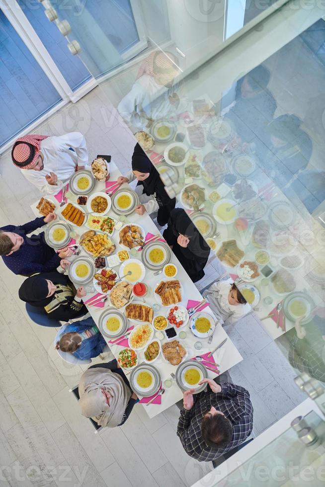 Top view of Muslim family making iftar dua to break fasting during Ramadan. photo