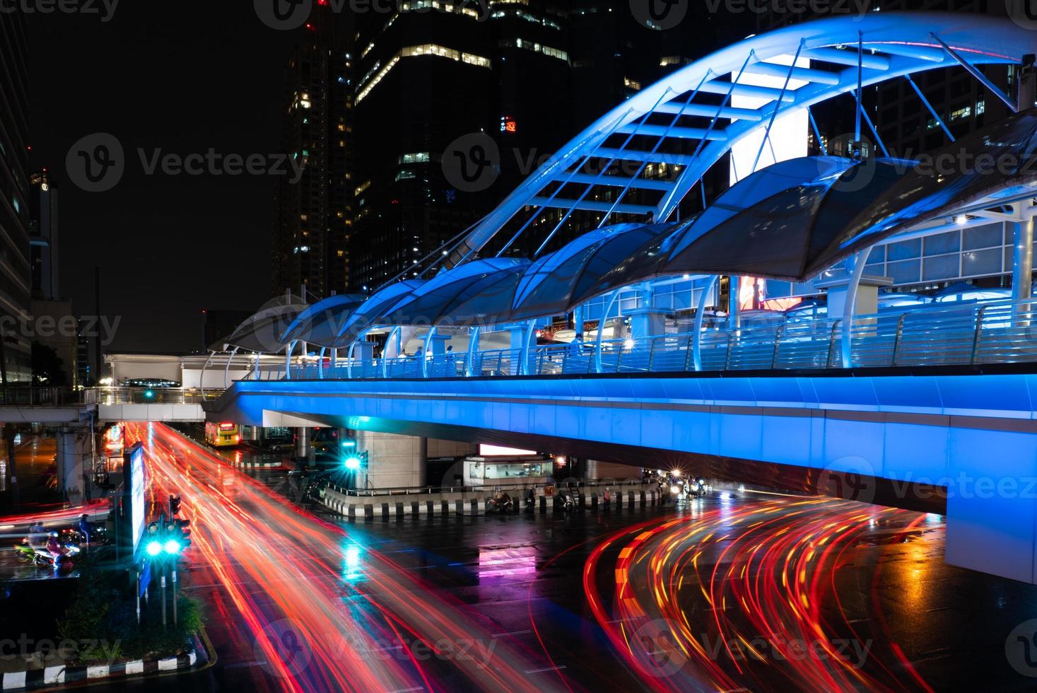 Cityscape of Bangkok at Night with Illumination of Skywalk and Vehicles photo