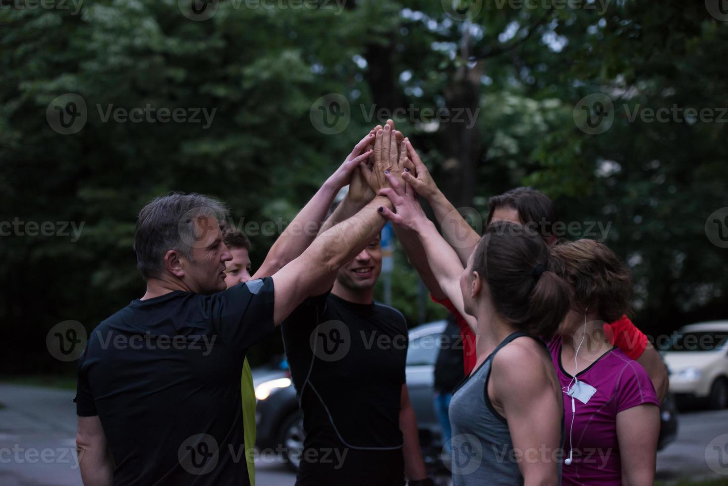 runners giving high five to each other photo