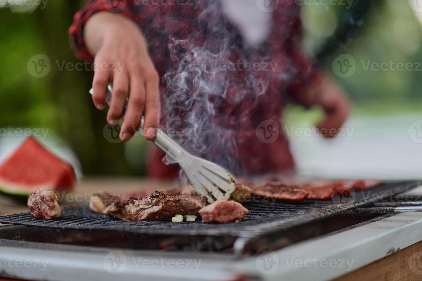 man cooking tasty food for french dinner party photo