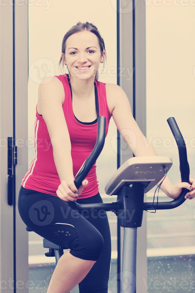 womanworkout  in fitness club on running track machine photo