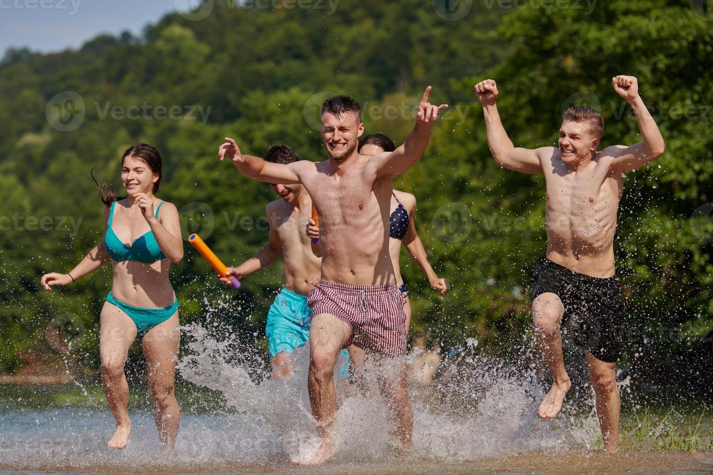 group of happy friends having fun on river photo