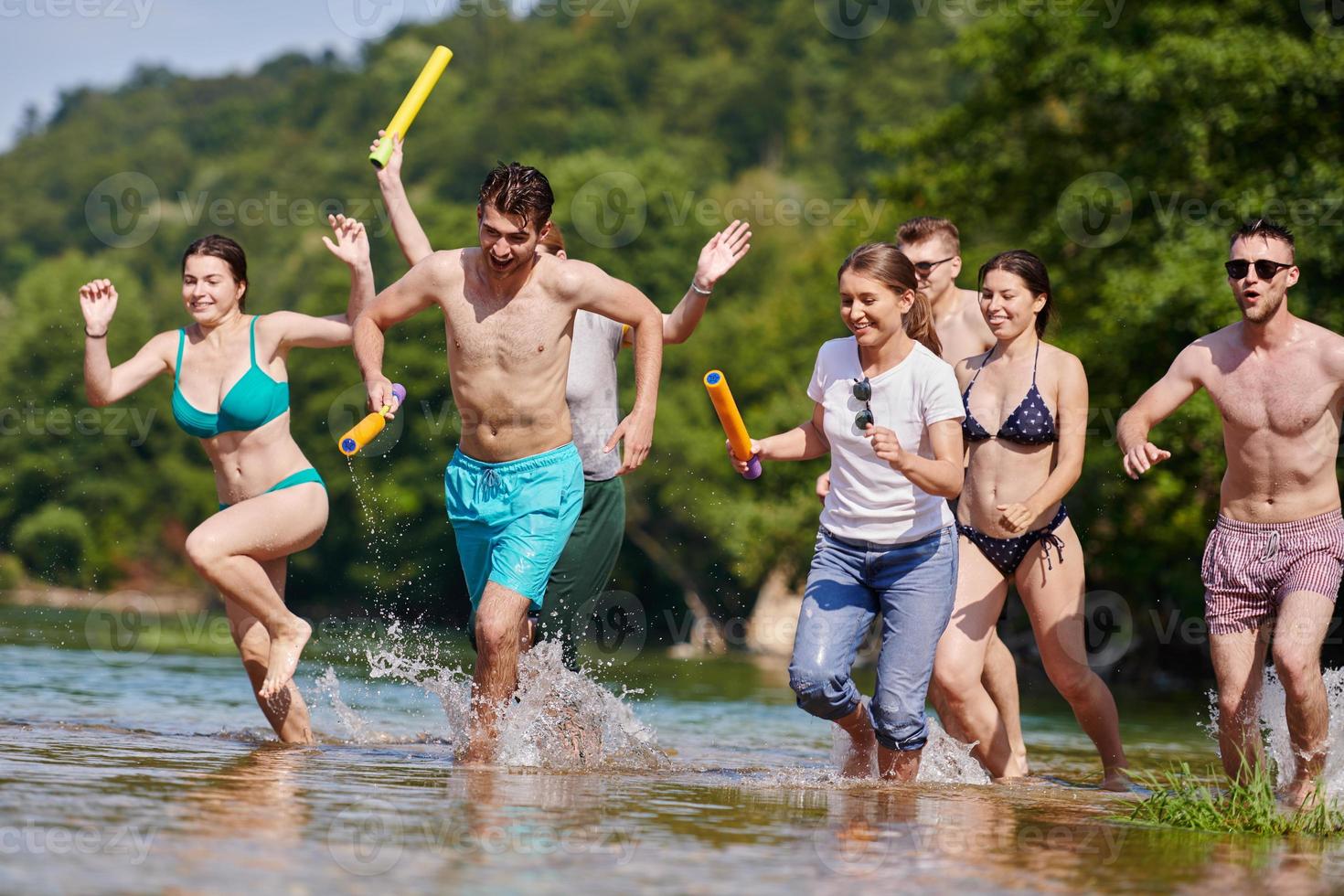 group of happy friends having fun on river photo