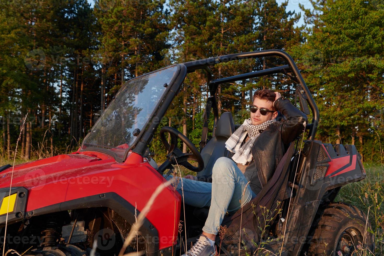 man enjoying beautiful sunny day while driving a off road buggy car photo