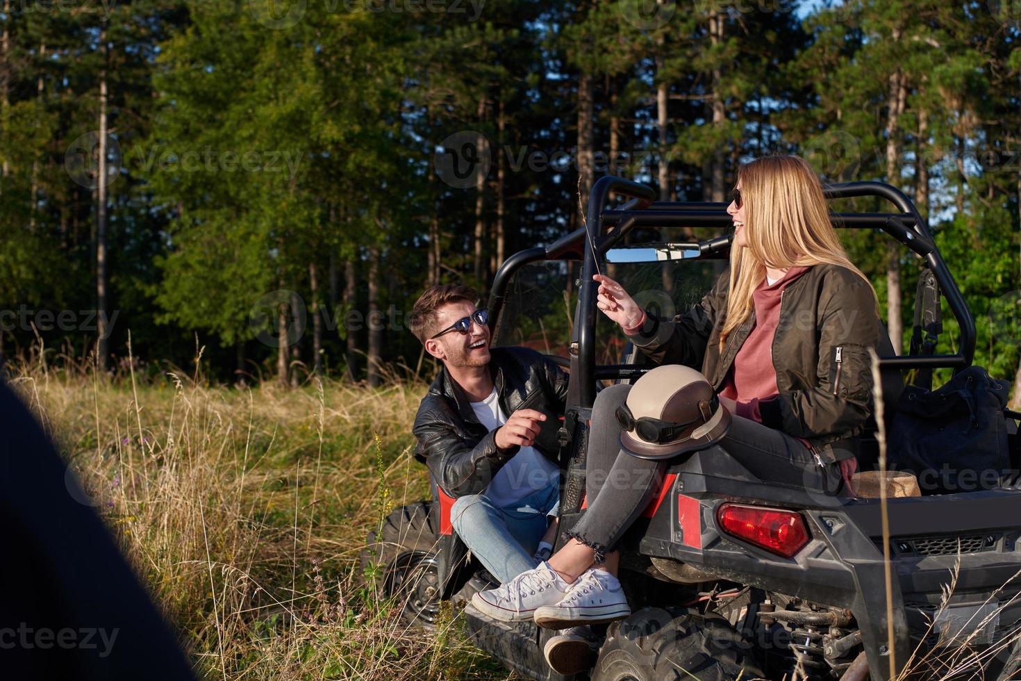 couple enjoying beautiful sunny day while driving a off road buggy photo