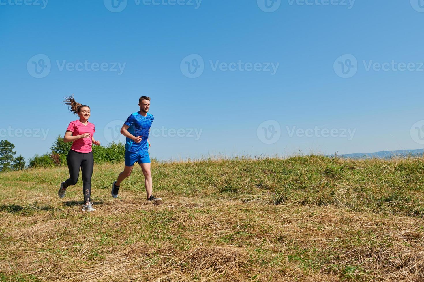 couple jogging in a healthy lifestyle on a fresh mountain air photo