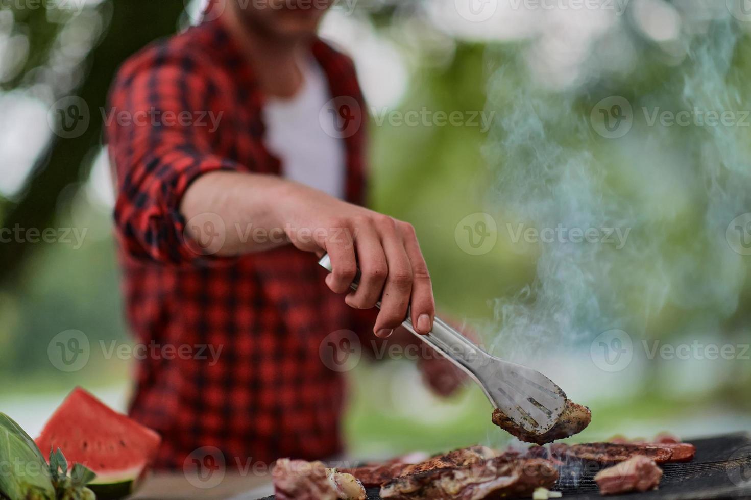 man cooking tasty food for french dinner party photo
