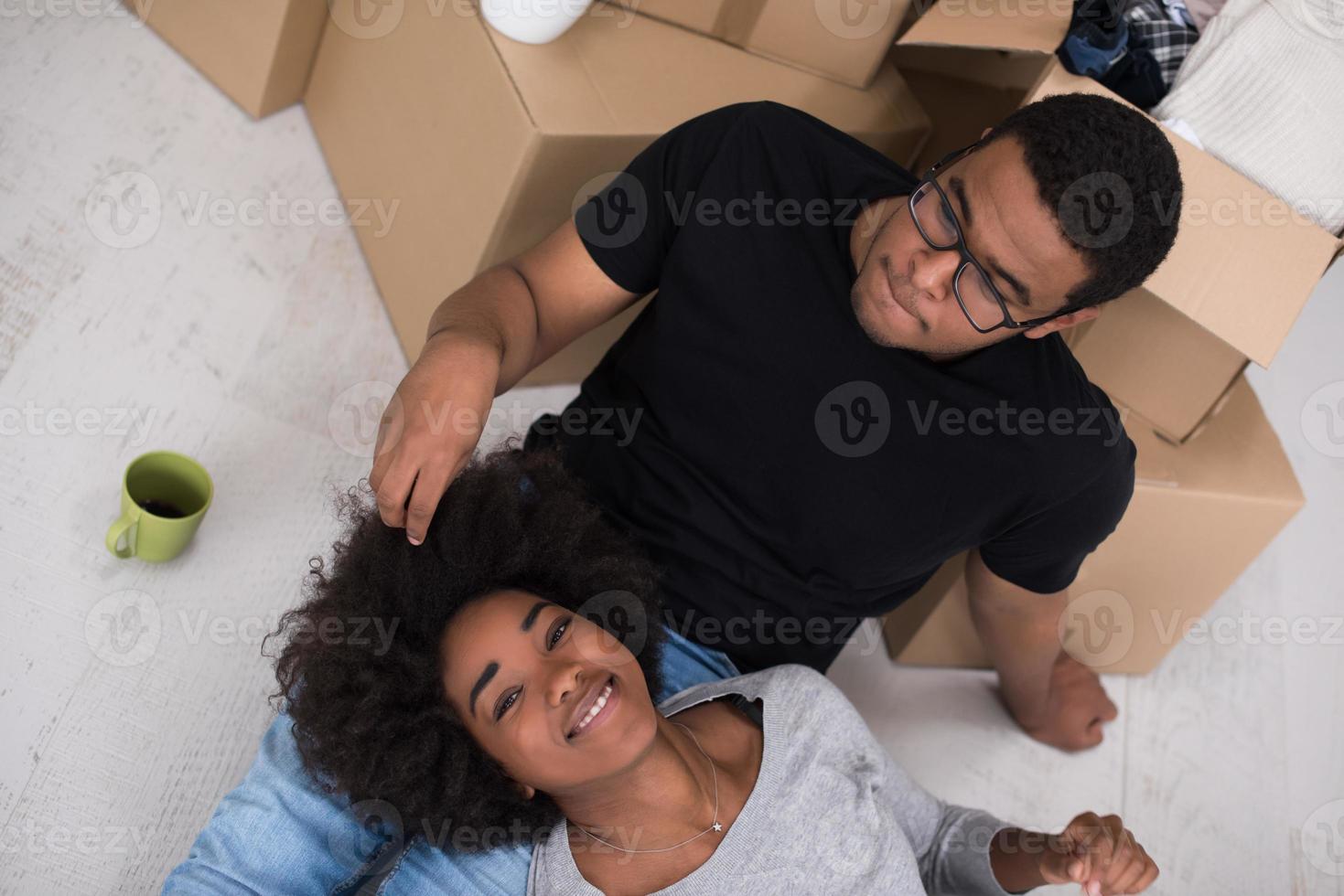 African American couple relaxing in new house photo