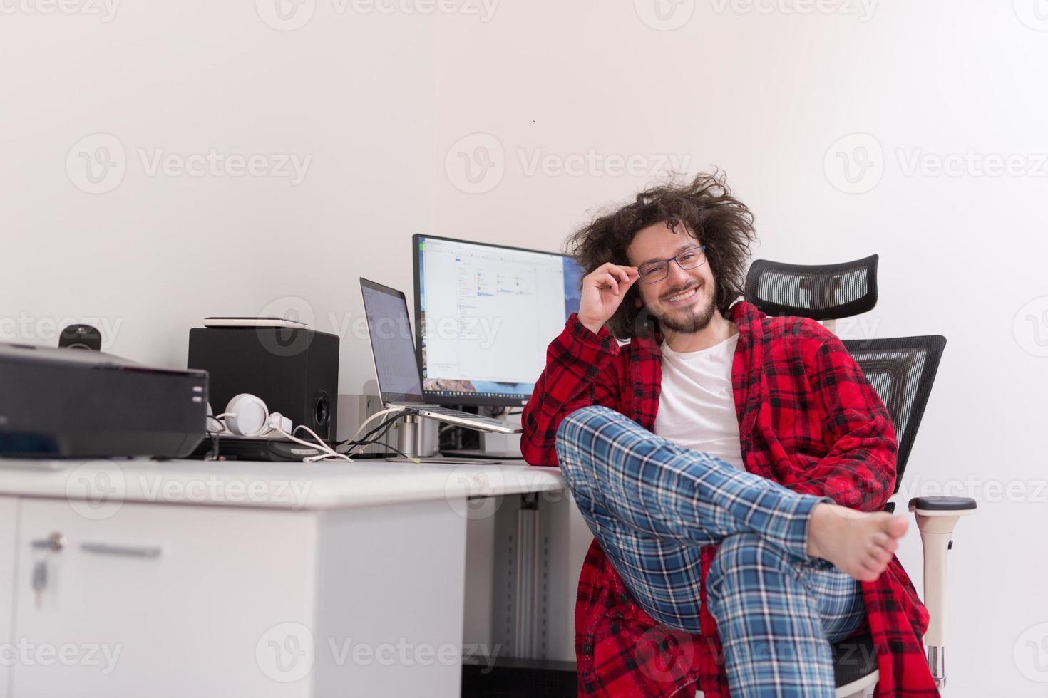 graphic designer in bathrobe working at home photo