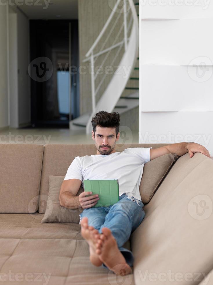 man using tablet computer from home photo