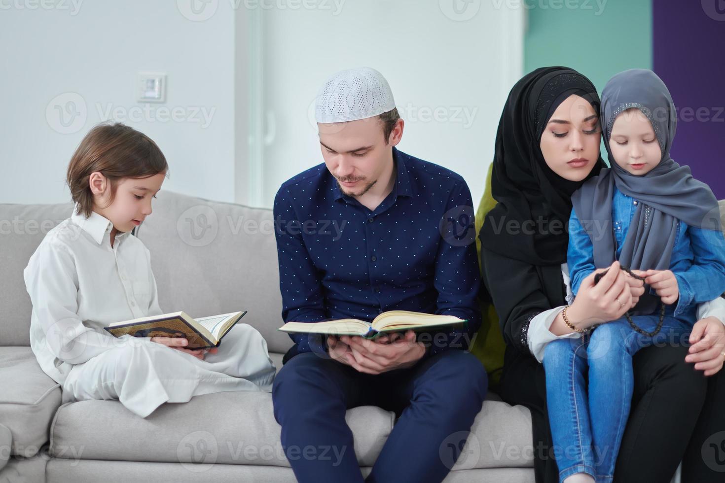 Young muslim family reading Quran during Ramadan photo