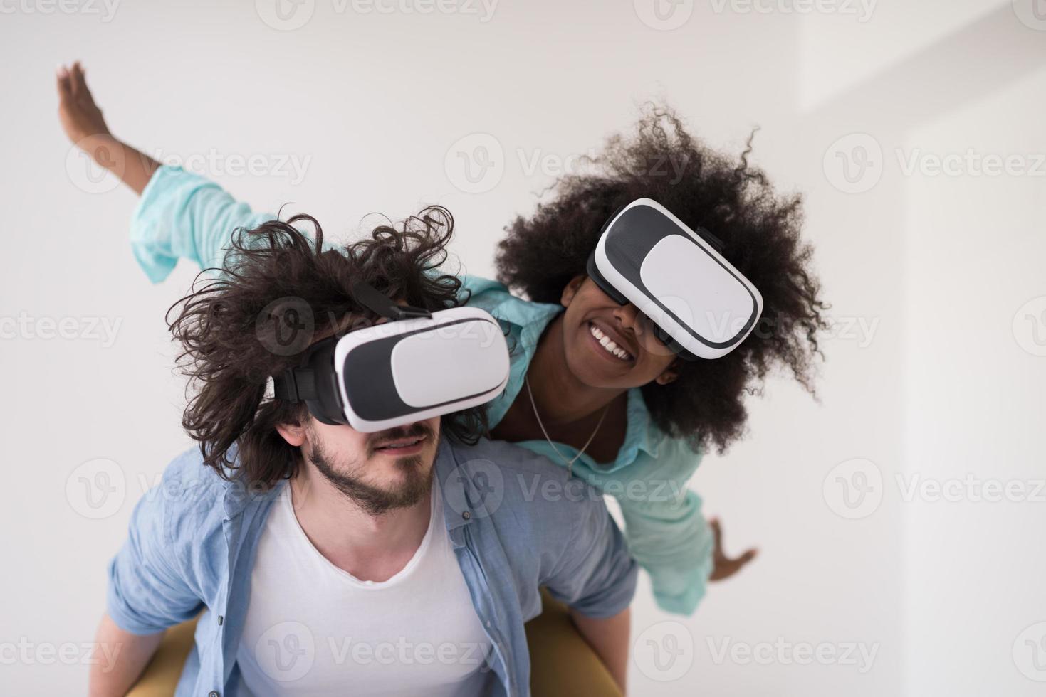 multiethnic couple getting experience using VR headset glasses photo