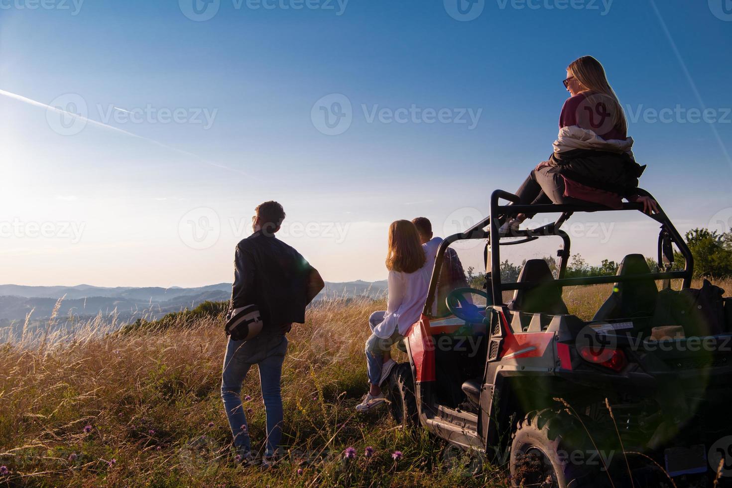 group of young people driving a off road buggy car photo