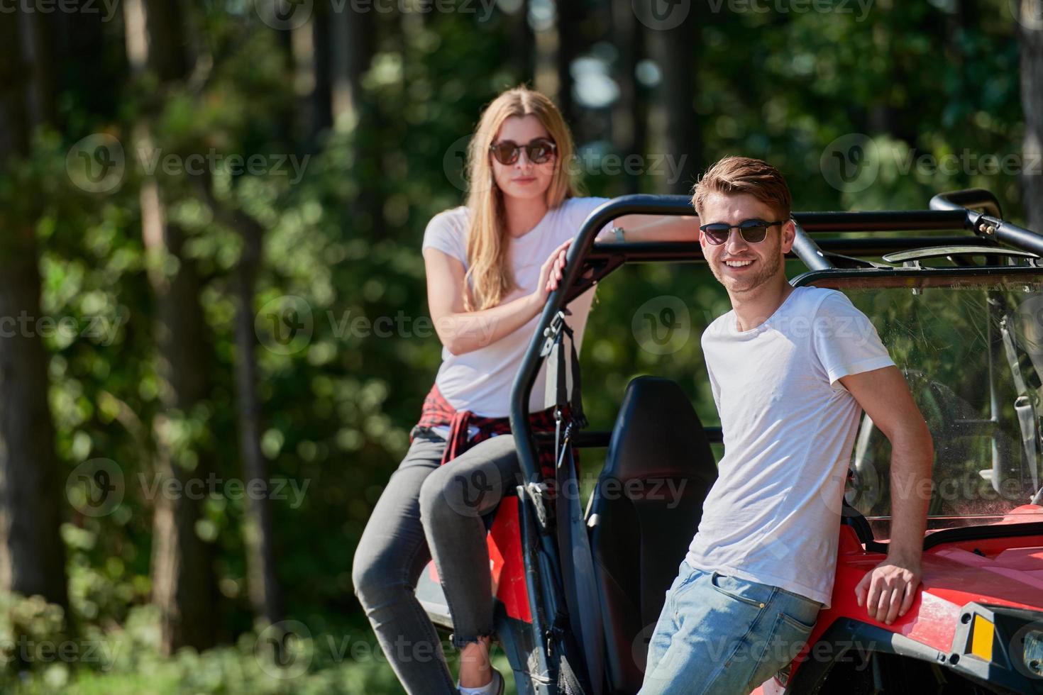 couple enjoying beautiful sunny day while driving a off road buggy photo
