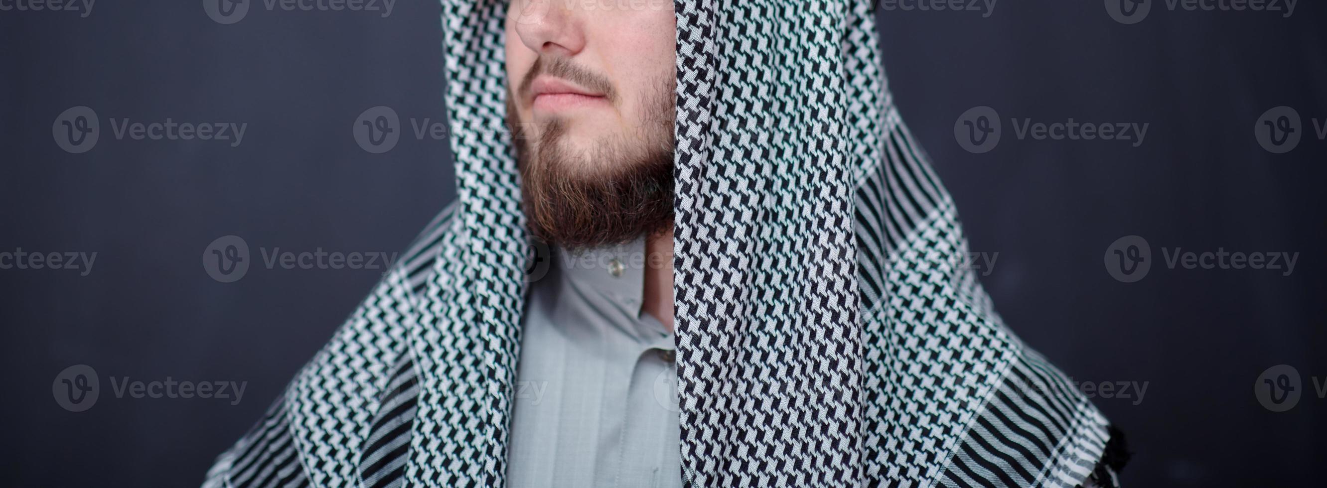 portrait of arabian man in front of black chalkboard photo