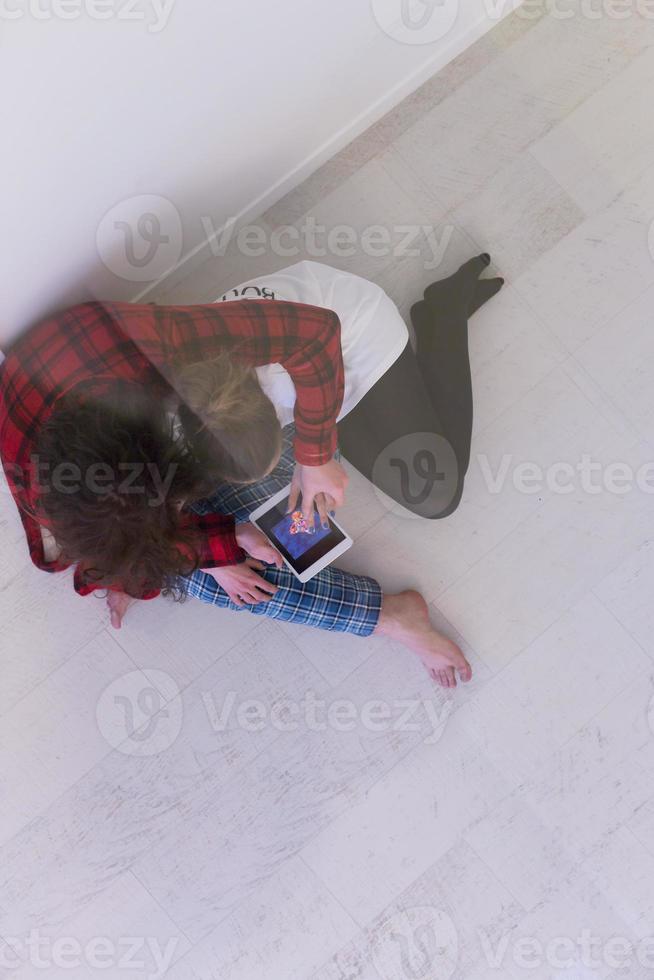 Young Couple using digital tablet on the floor photo