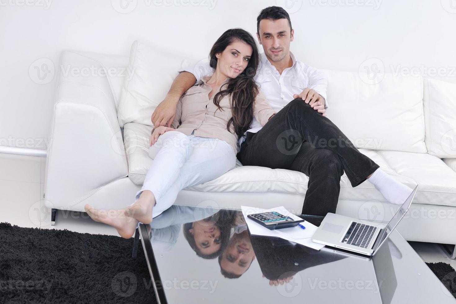 joyful couple relax and work on laptop computer at modern home photo
