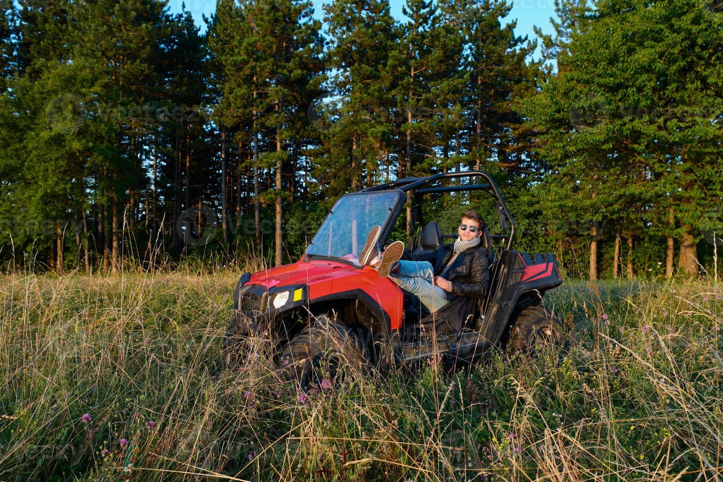 man enjoying beautiful sunny day while driving a off road buggy car photo