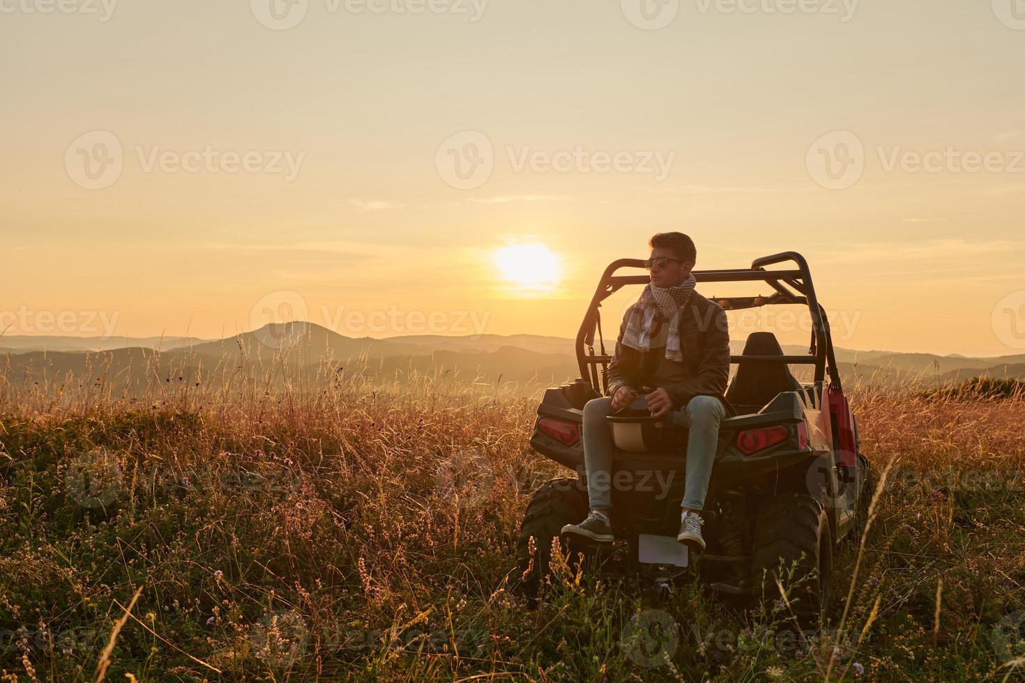 man enjoying beautiful sunny day while driving a off road buggy car photo