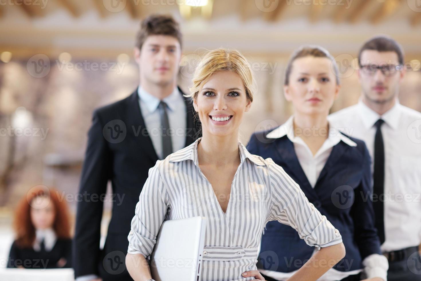 business woman standing with her staff at conference photo