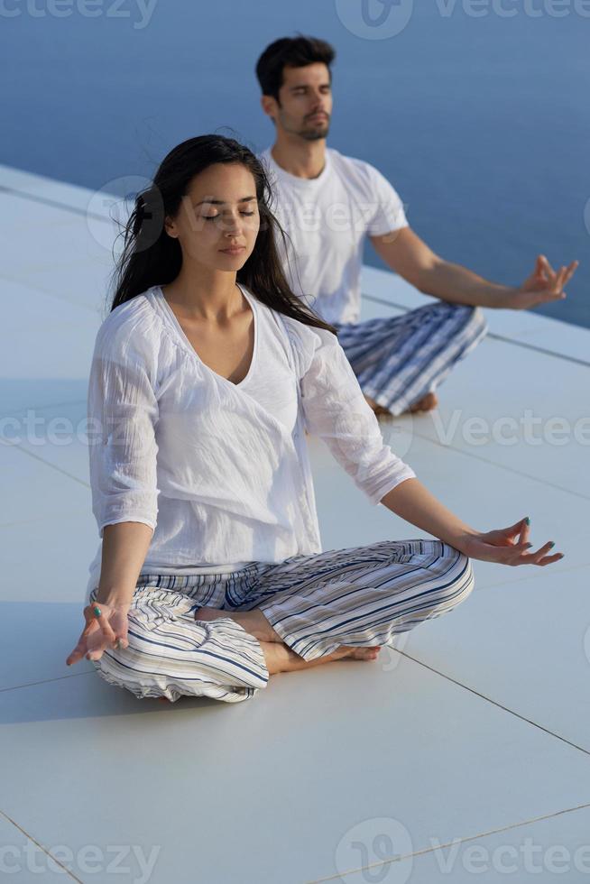 young couple practicing yoga photo