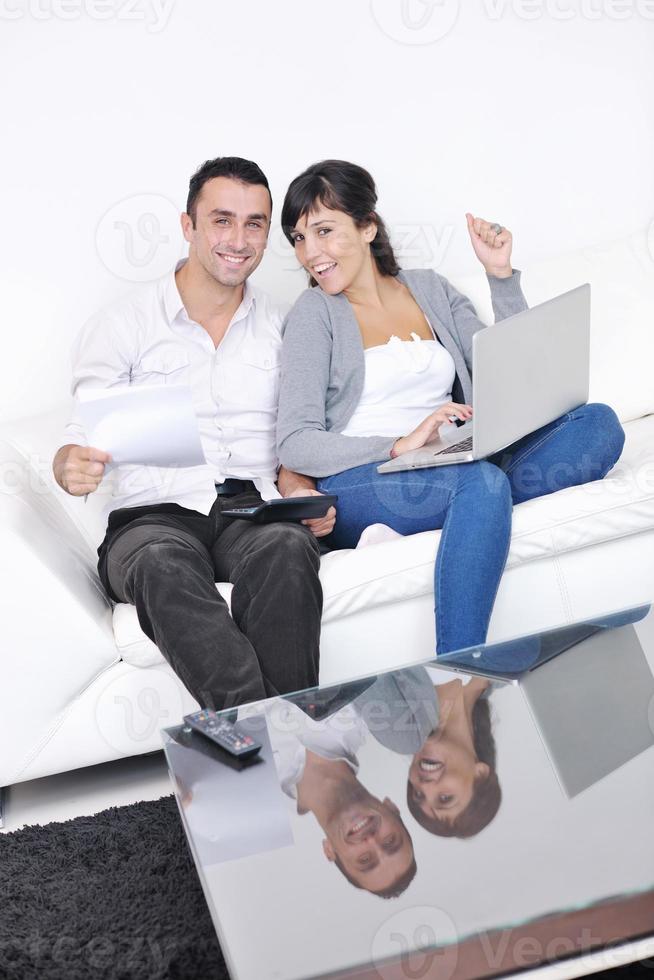 joyful couple relax and work on laptop computer at modern home photo