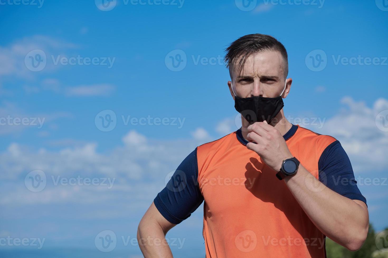 man with protective mask  relaxing after running photo