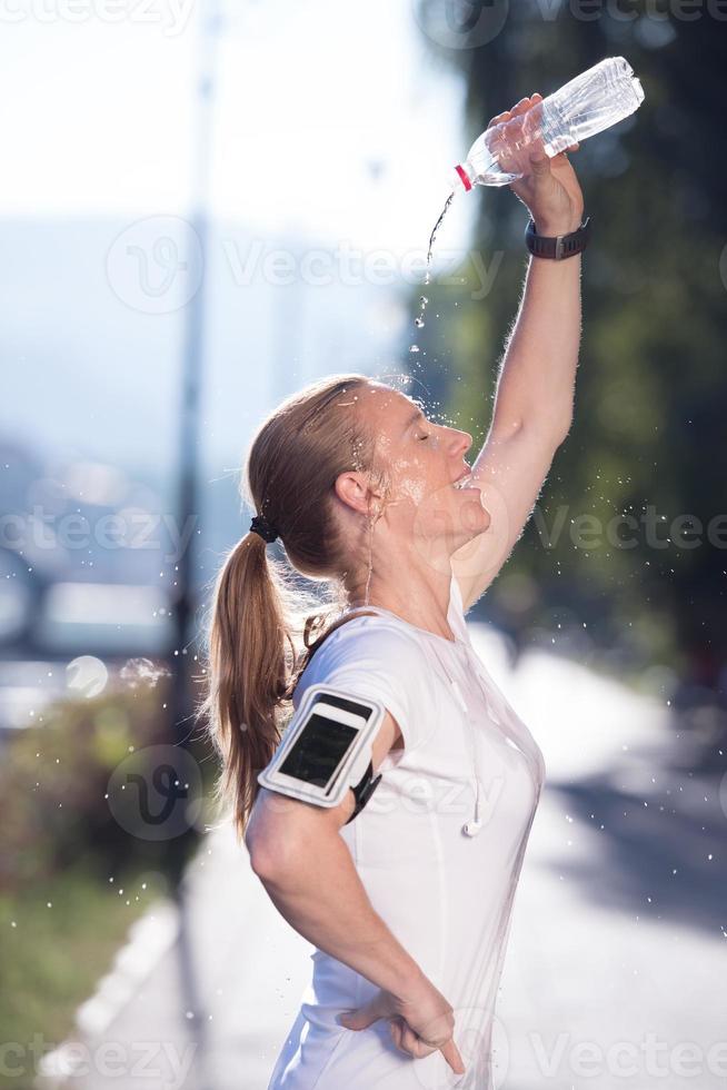 woman drinking  water after  jogging photo