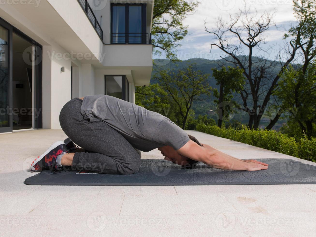 man doing morning yoga exercises photo