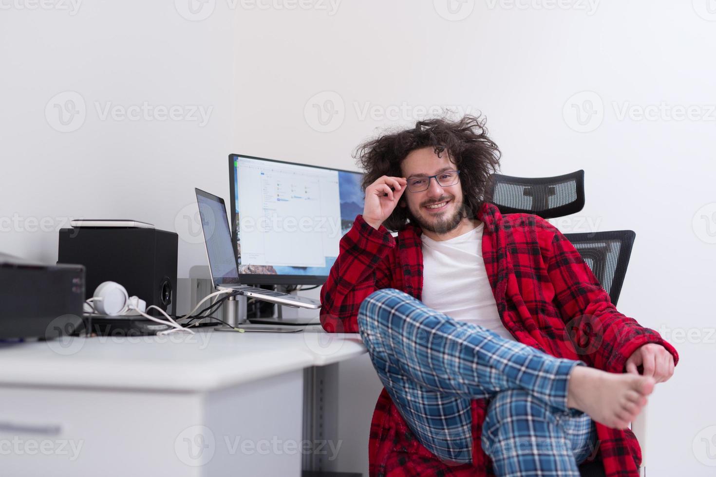 graphic designer in bathrobe working at home photo