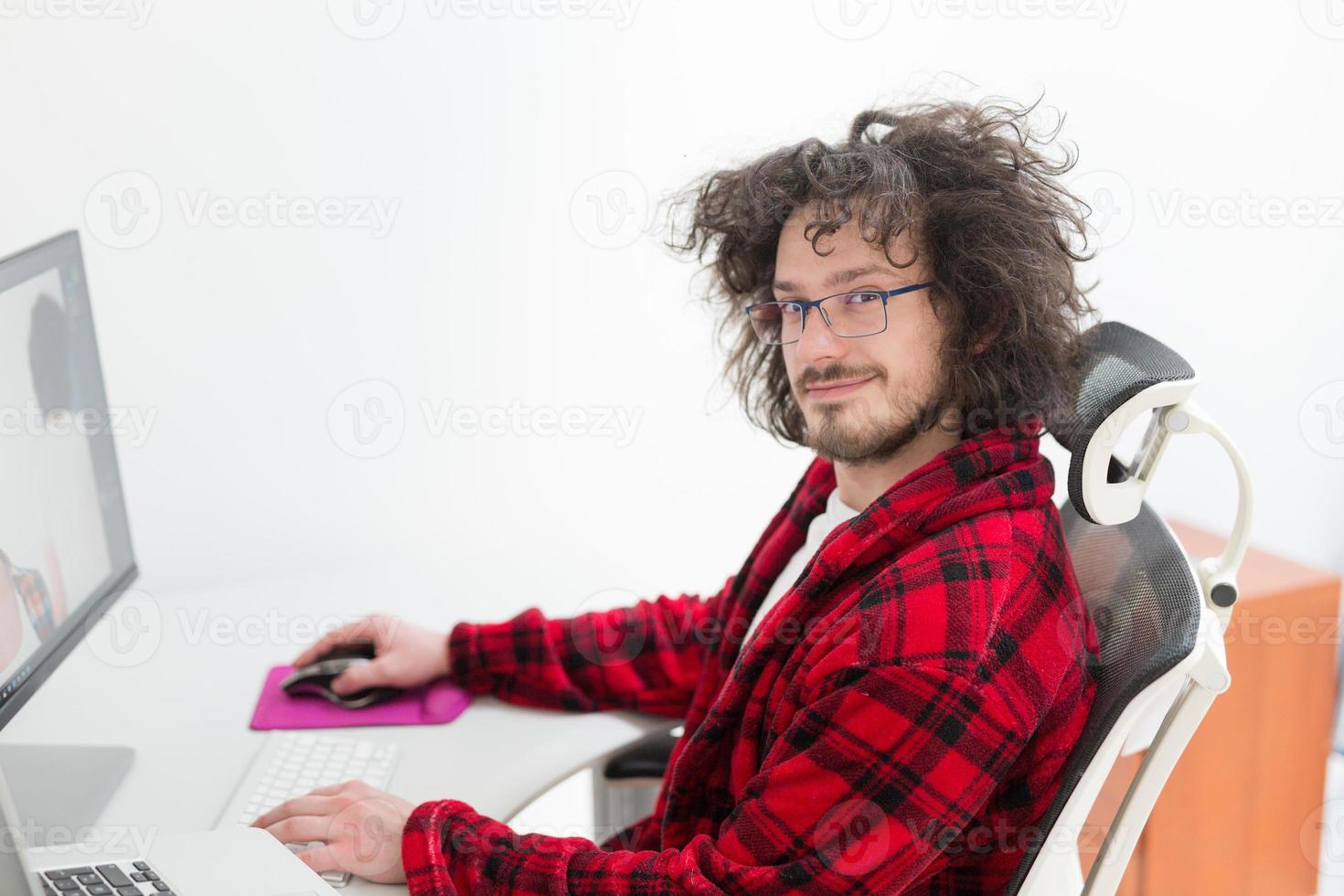 graphic designer in bathrobe working at home photo