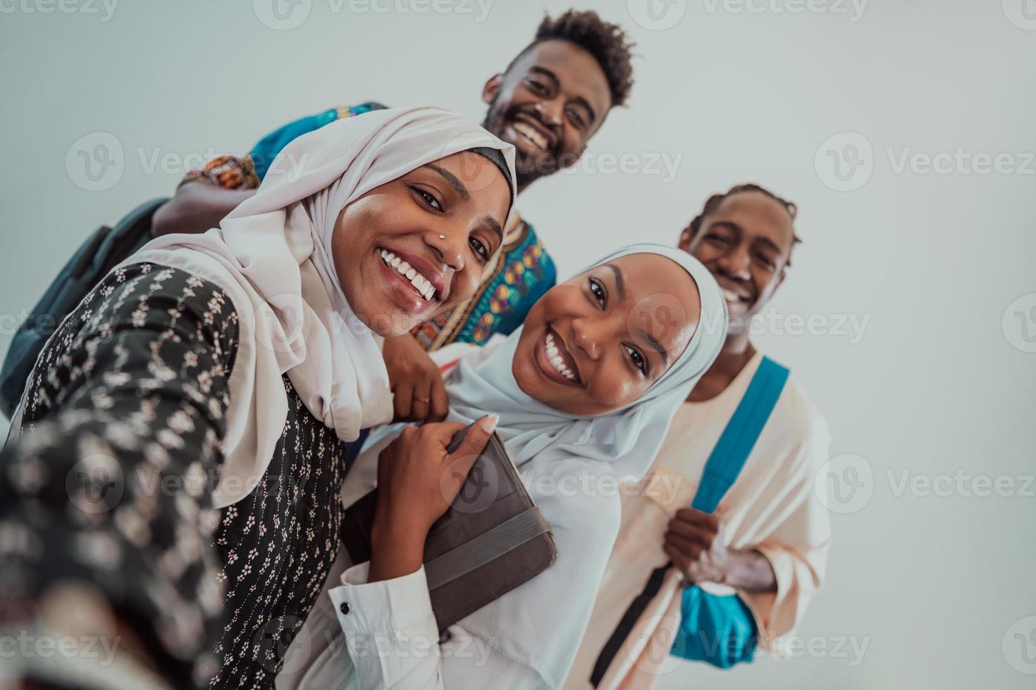 A group of multiethnic students take a selfie with a smartphone on a white background. Selective focus photo
