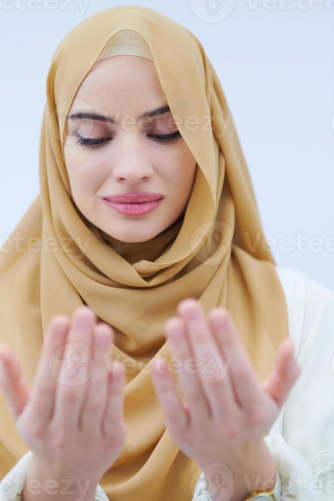 muslim woman making traditional prayer to God photo