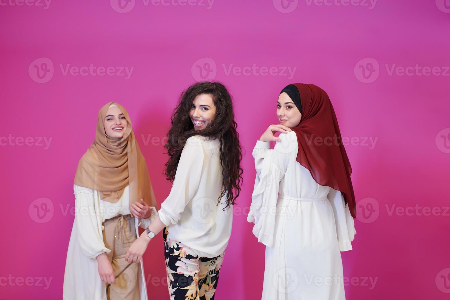 muslim women in fashionable dress isolated on pink photo