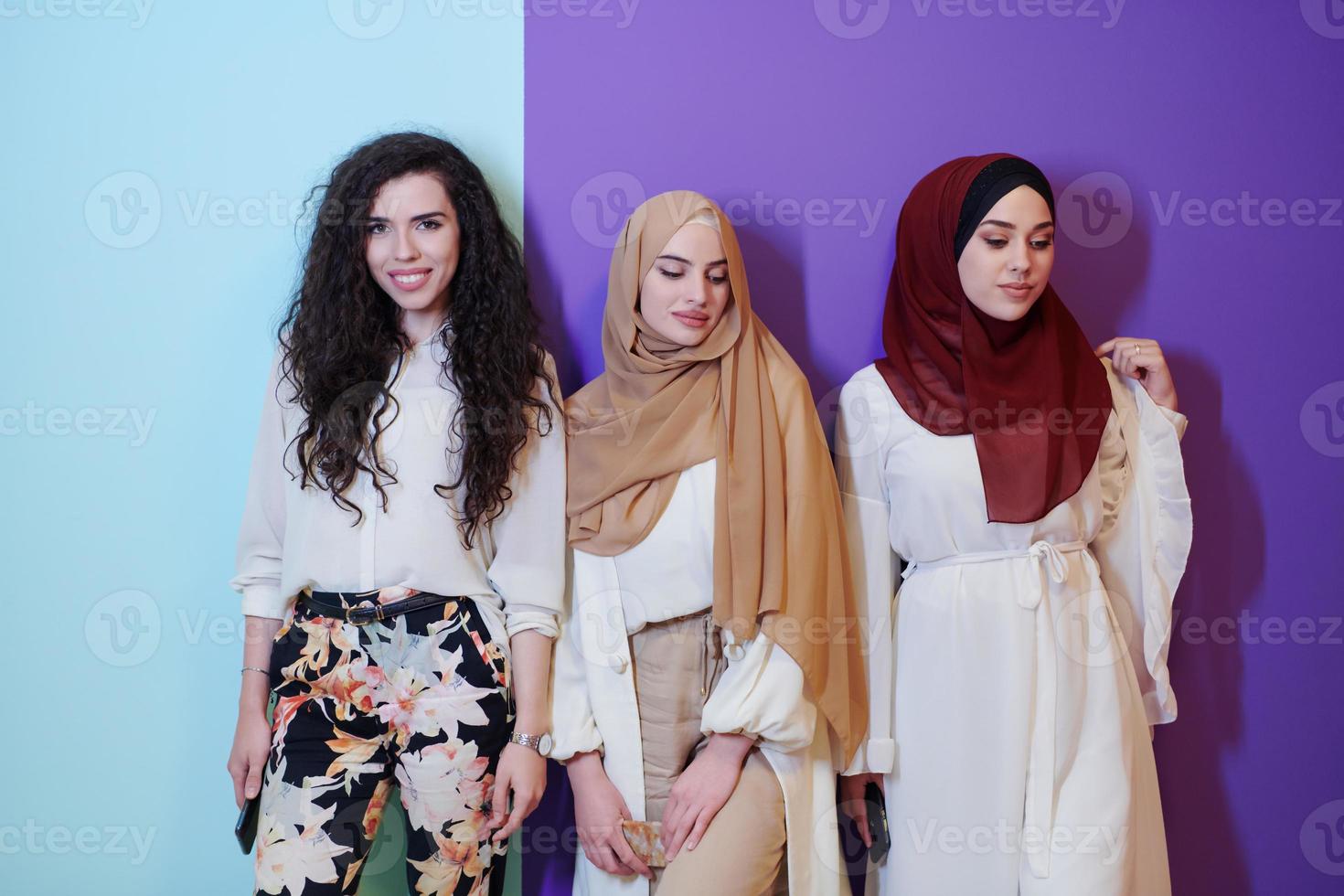 muslim women in fashionable dress isolated on colorful background photo