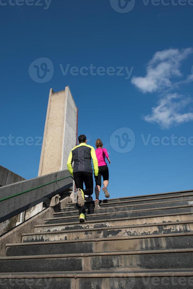 young  couple jogging on steps photo