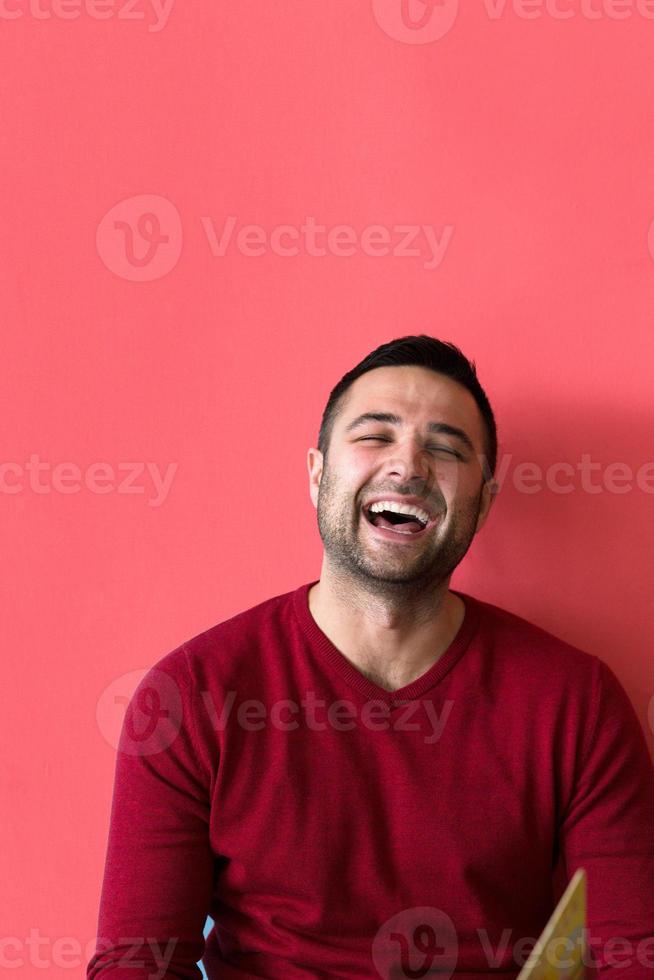 man sitting on floor and reading a book photo