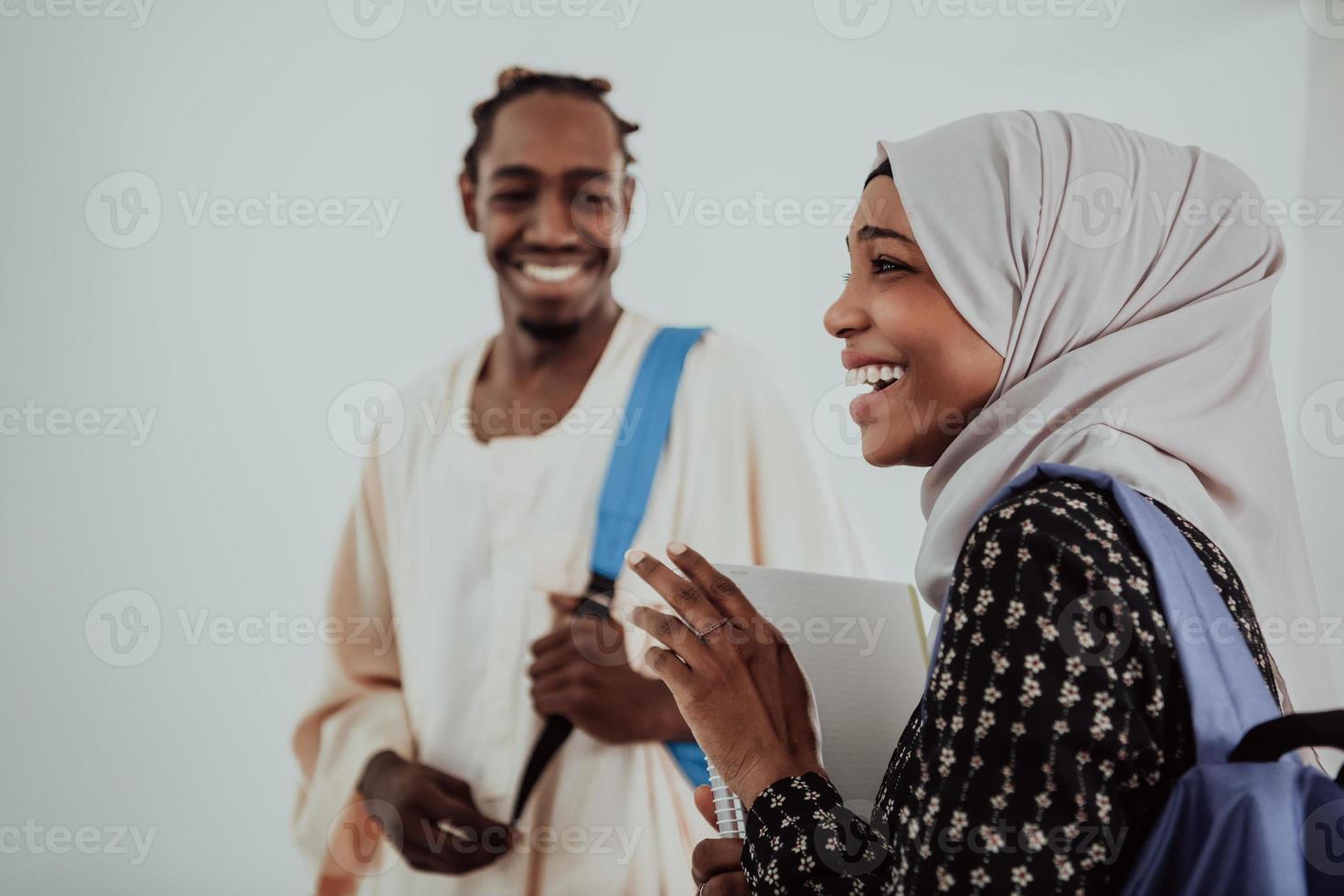 Group of happy african students having conversation and team meeting working together on homework girls wearing traidiional sudan muslim hijab fashion photo