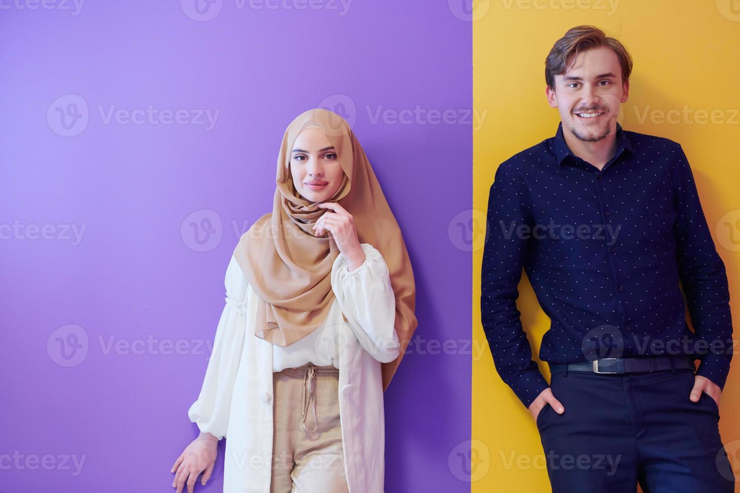 portrait of young muslim couple isolated on colorful background photo