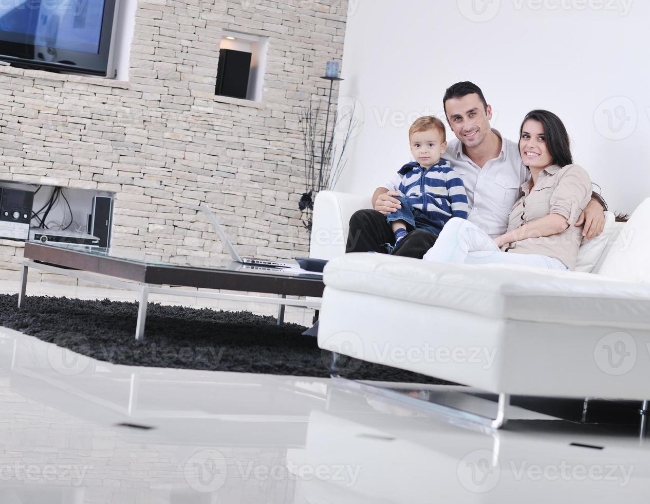 happy young family have fun  with tv in backgrund photo