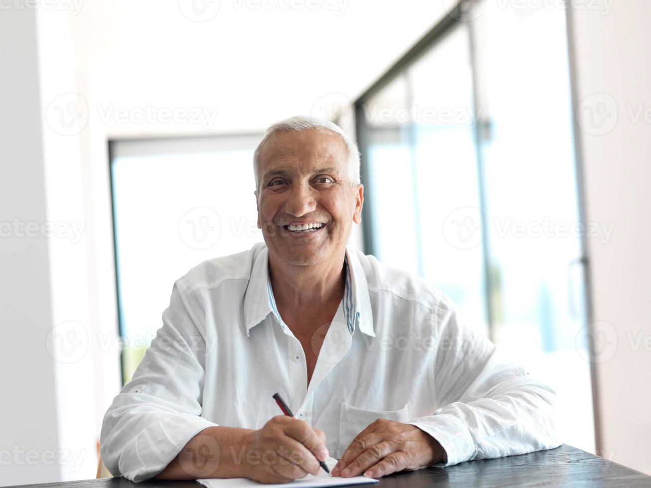 Portrait of senior man relaxing in sofa photo