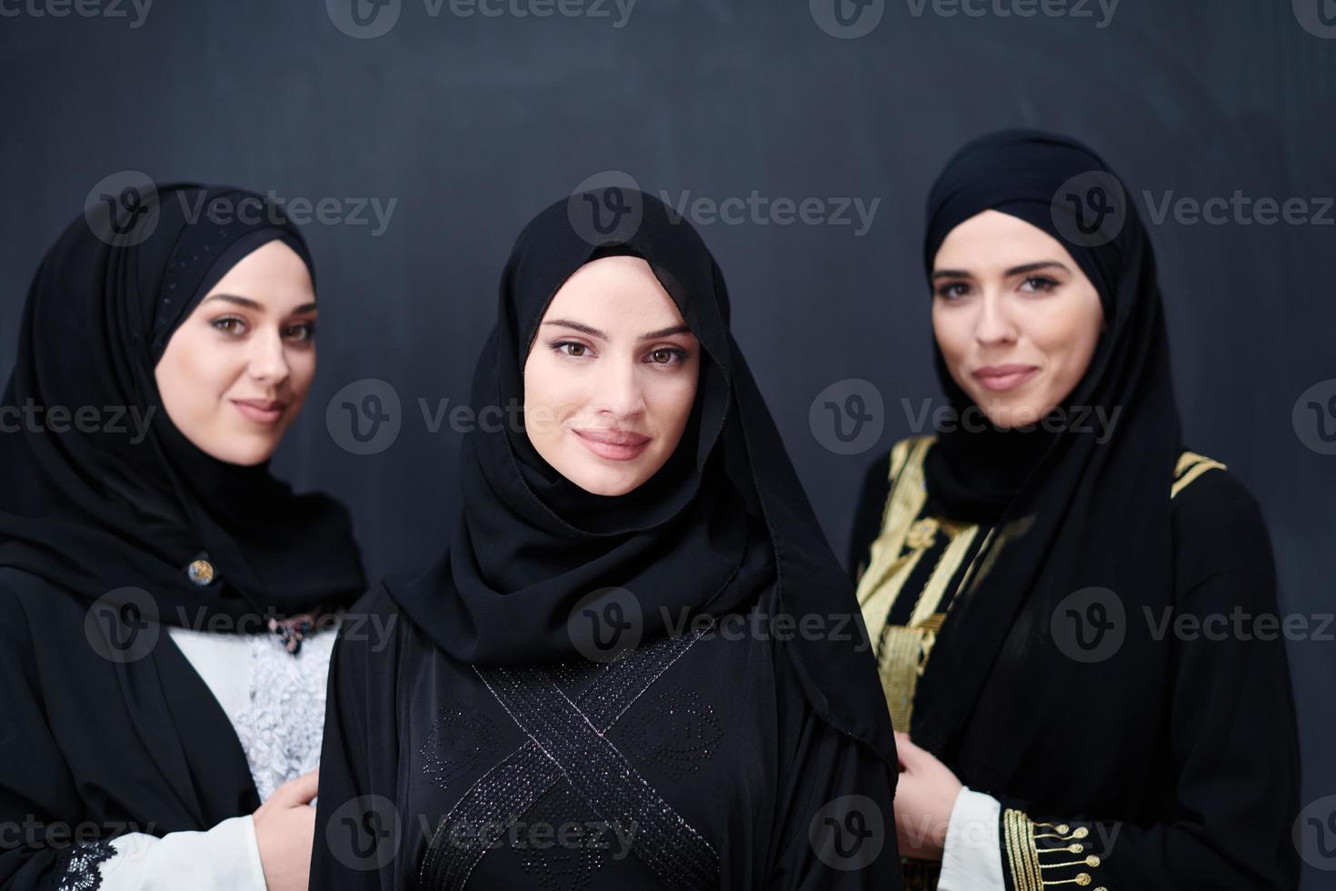 portrait of beautiful muslim women in fashionable dress photo