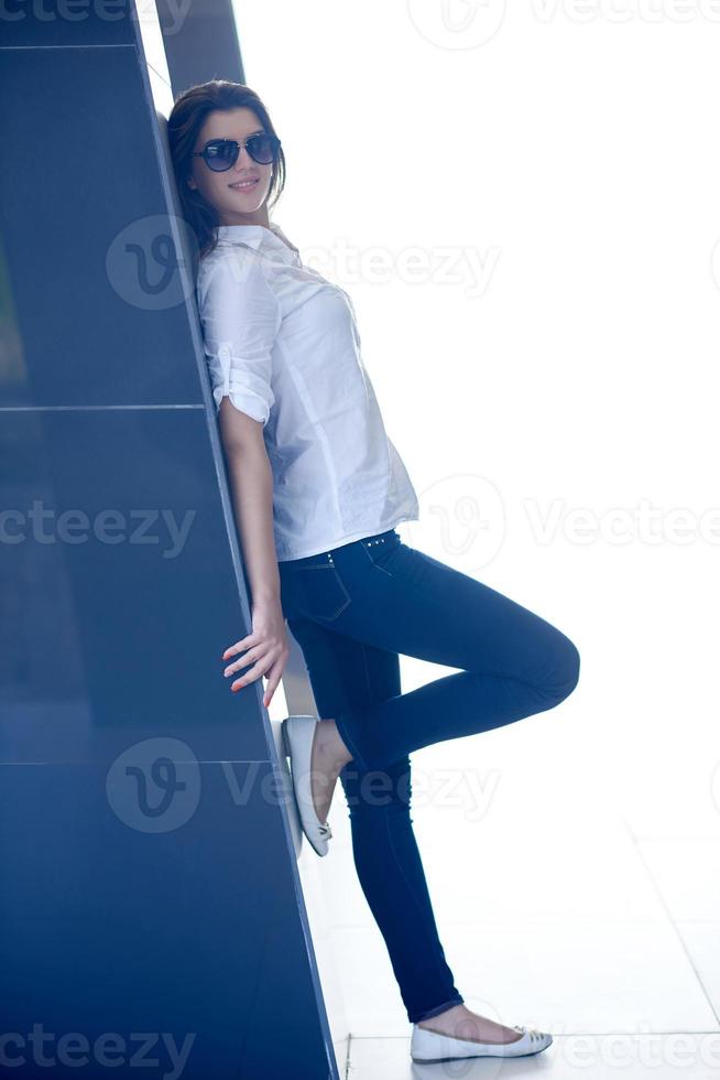 relaxed woman in front of luxury modern home photo