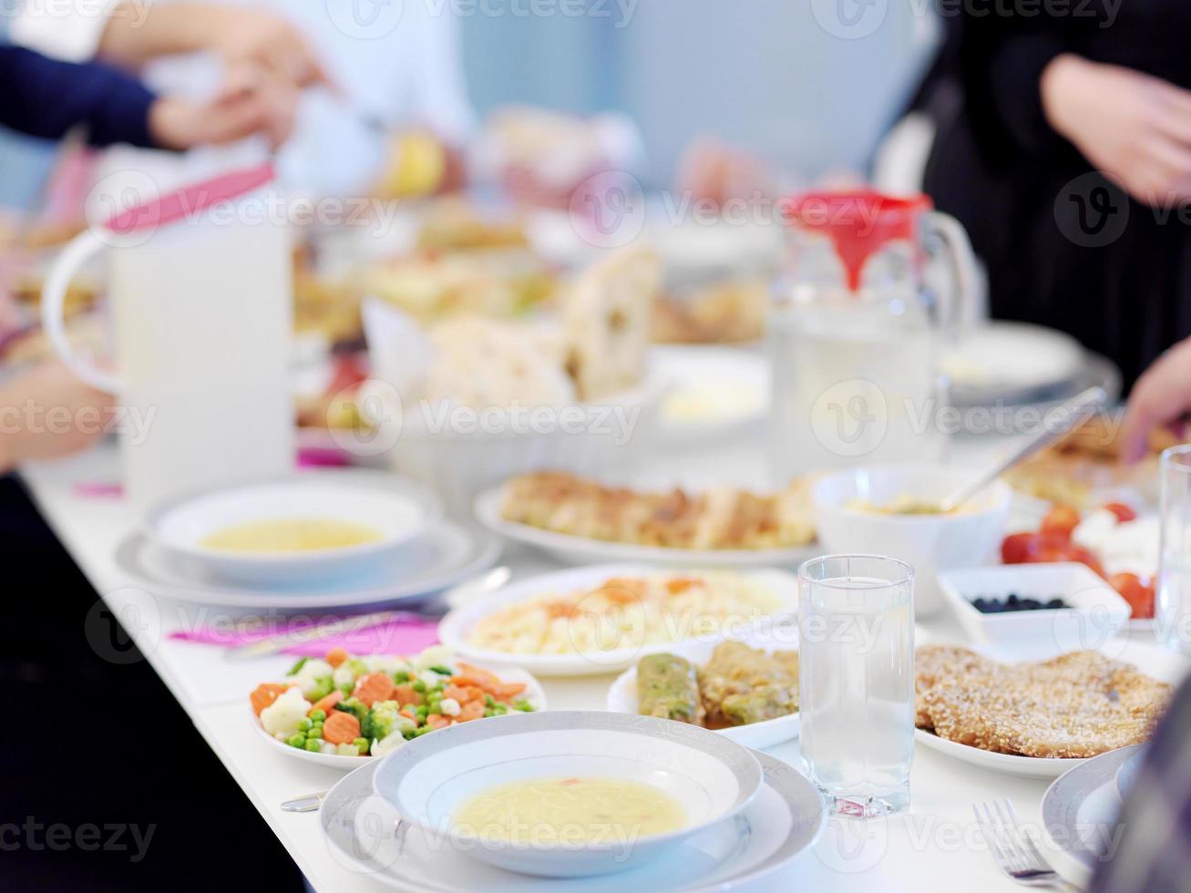 Muslim family having Iftar dinner drinking water to break feast photo