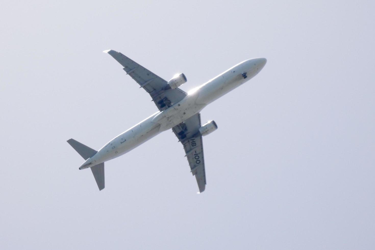 commercial aircraft flying under blue skies and arriving at the airport photo