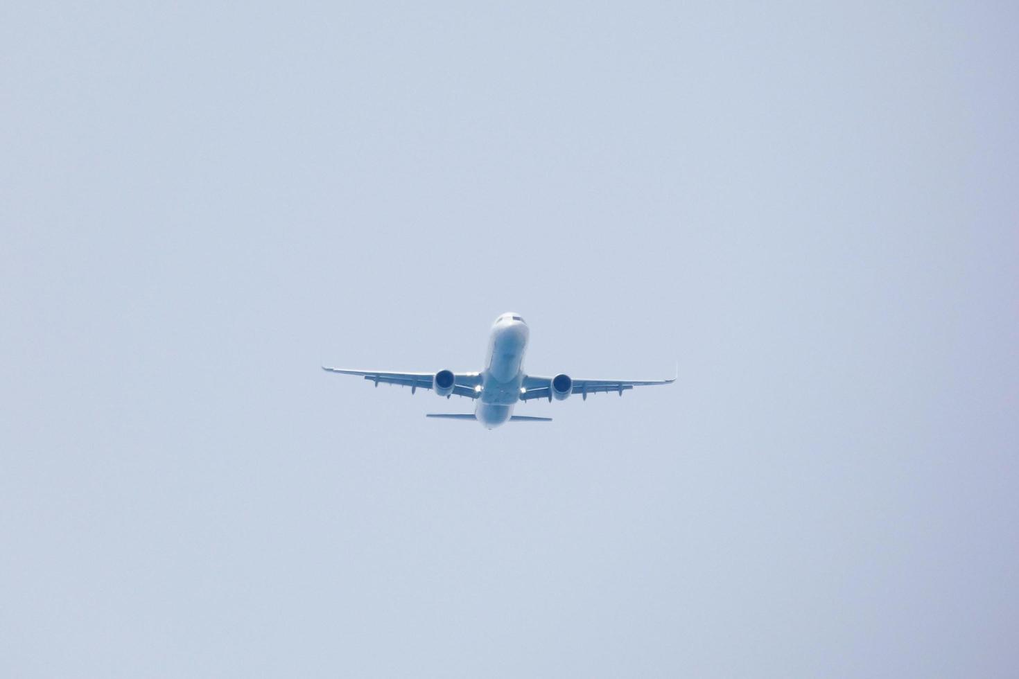 commercial aircraft flying under blue skies and arriving at the airport photo