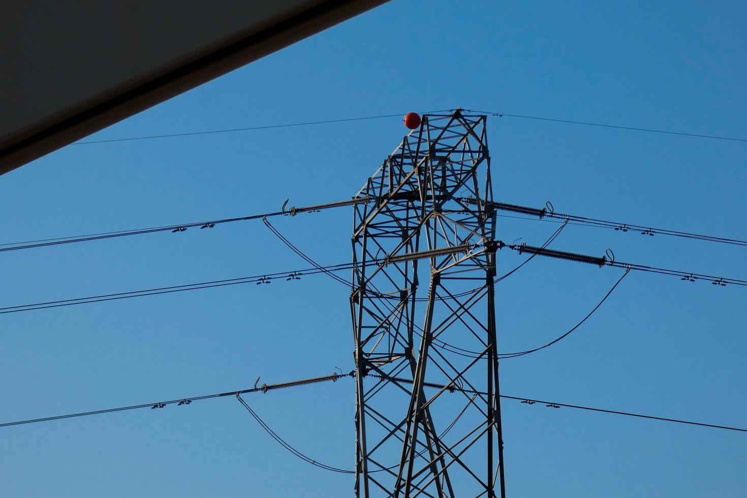 metallic electric towers supporting copper cables for transporting electricity photo