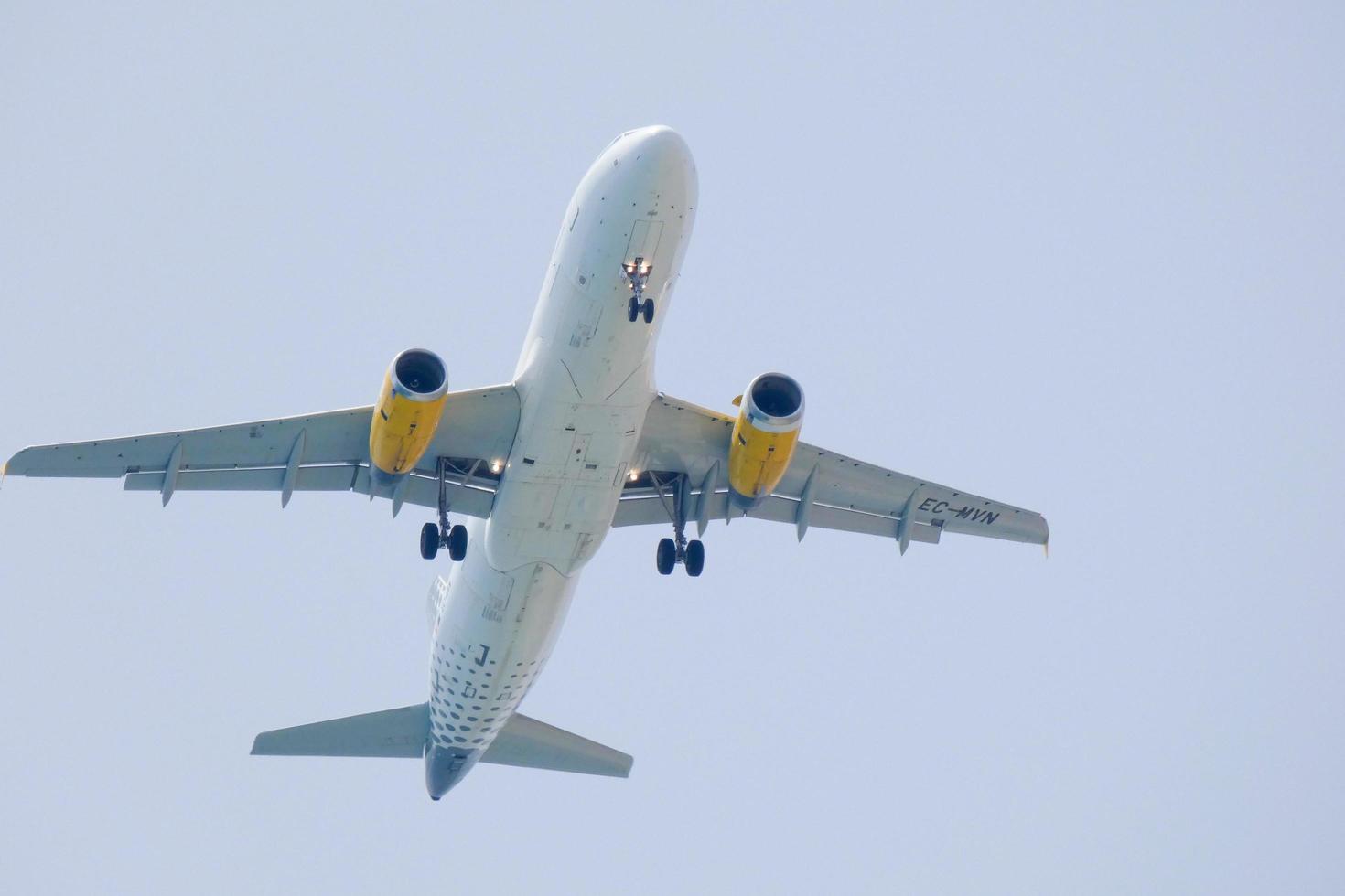 commercial aircraft flying under blue skies and arriving at the airport photo