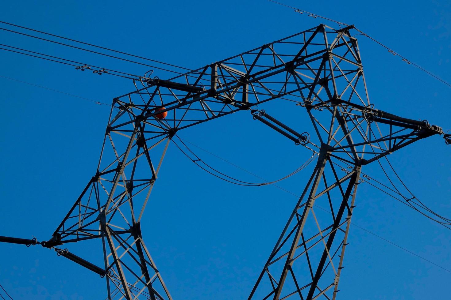 metallic electric towers supporting copper cables for transporting electricity photo